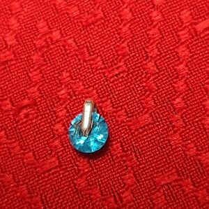 Blue zircon pendant hanging on a silver hoop pendant. 0.4cm